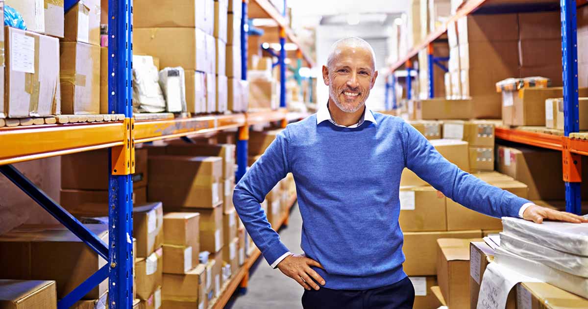 man standing in well-organized warehouse